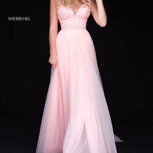 Sherri Hill style 51866. Flower appliqued V neck bodice with tulle skirt. Pink